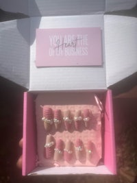 a pink box with pink nails in it